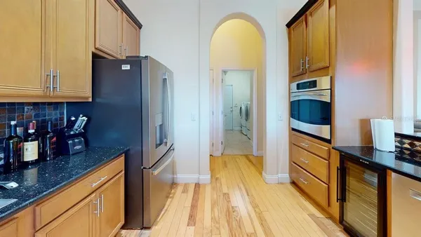 a kitchen with stainless steel appliances granite countertop a sink and cabinets