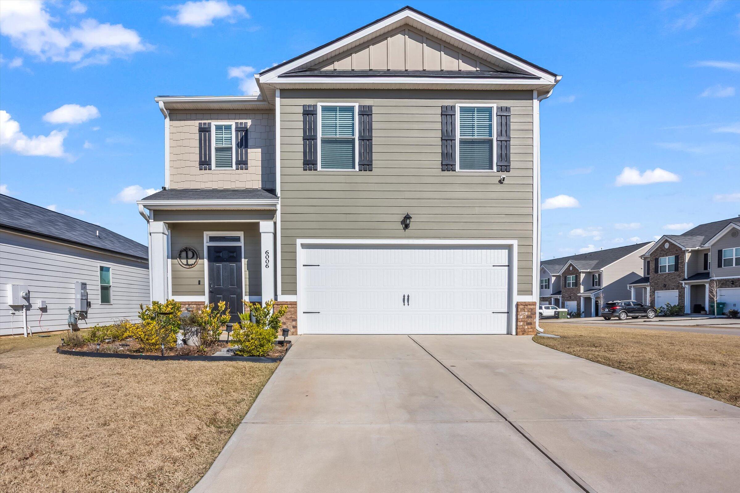 6006 Beadlow Street Aiken, SC 29801 - Photo 1 of 14 a front view of a house with a yard