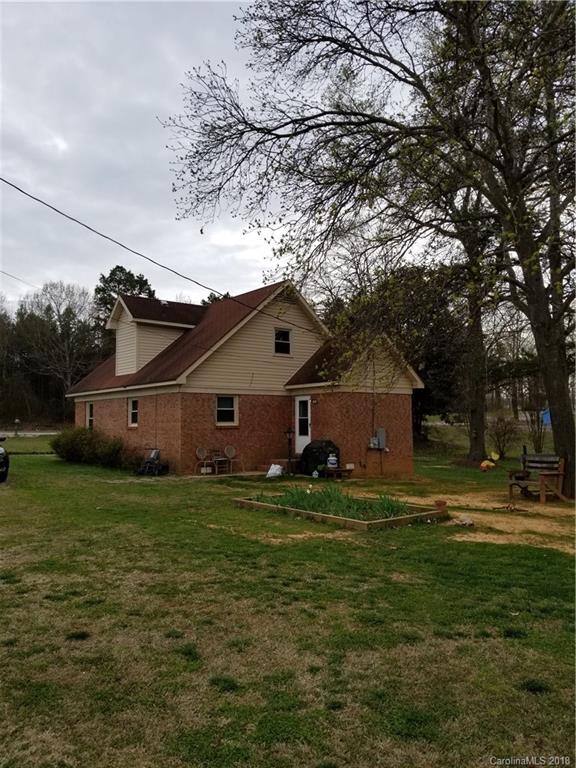 126 West Sandy Ridge Road Monroe, NC 28112 - Photo 3 of 14 a house that is sitting in the grass with large trees
