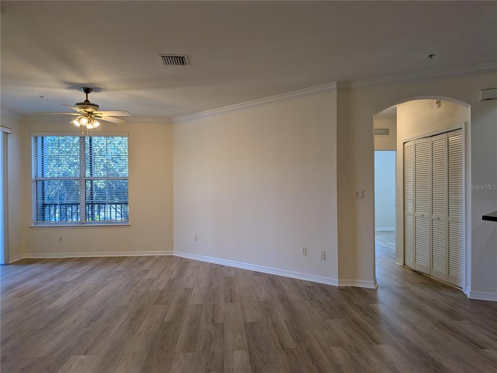 11562 Amidship Lane, Unit 208 Windermere, FL 34786 - Photo 13 of 31 an empty room with wooden floor chandelier and windows