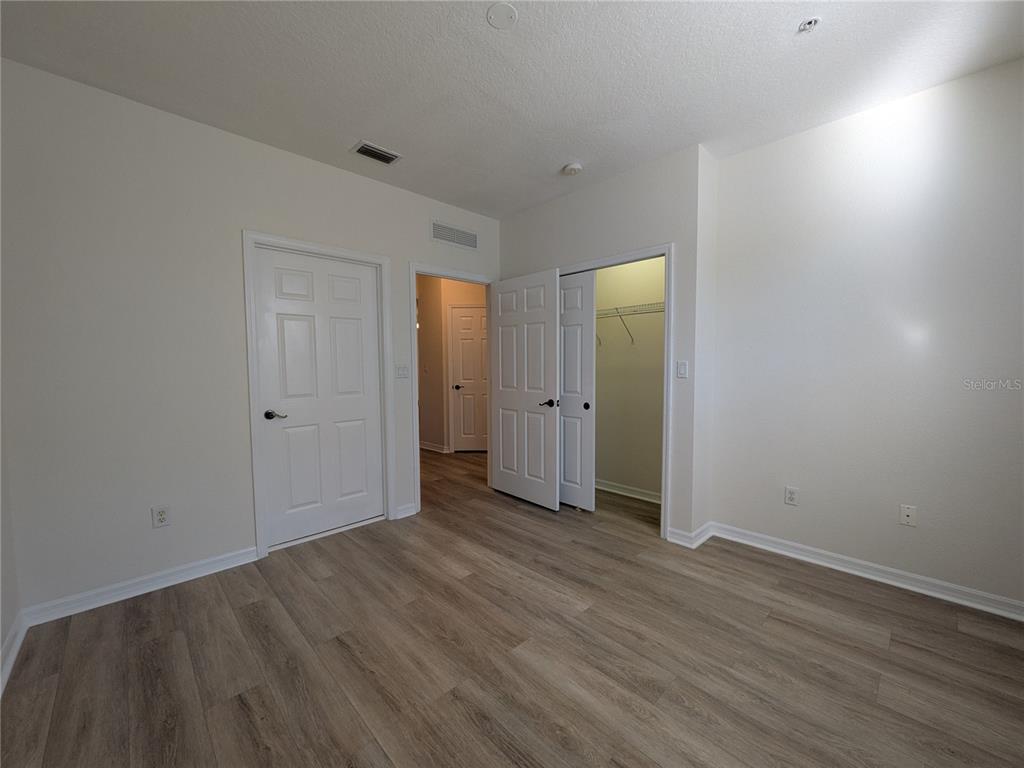 11562 Amidship Lane, Unit 208 Windermere, FL 34786 - Photo 17 of 31 a view of an empty room with wooden floor and closet