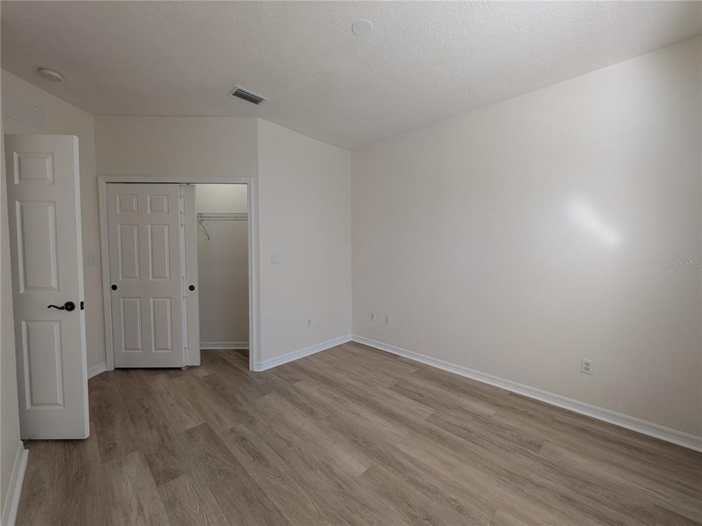 11562 Amidship Lane, Unit 208 Windermere, FL 34786 - Photo 19 of 31 a view of an empty room with wooden floor