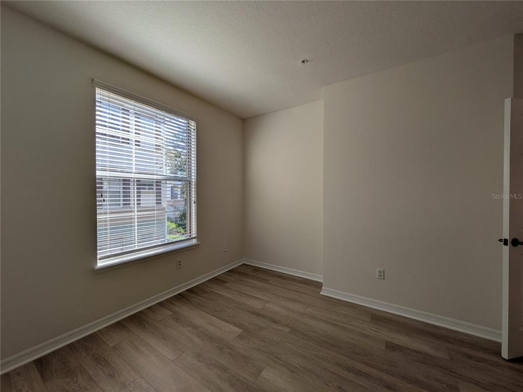 11562 Amidship Lane, Unit 208 Windermere, FL 34786 - Photo 20 of 31 a view of an empty room with wooden floor and a window