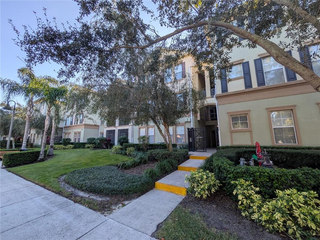 11562 Amidship Lane, Unit 208 Windermere, FL 34786 - Photo 2 of 31 a front view of a house with a yard