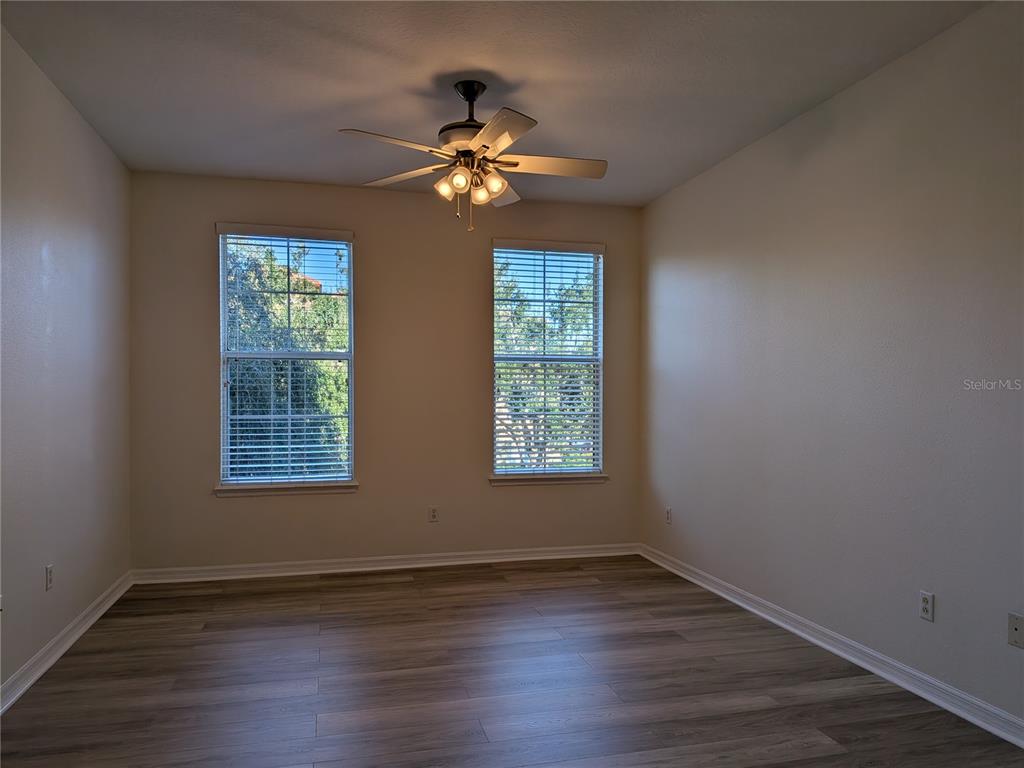 11562 Amidship Lane, Unit 208 Windermere, FL 34786 - Photo 23 of 31 a view of an empty room with wooden floor and a window