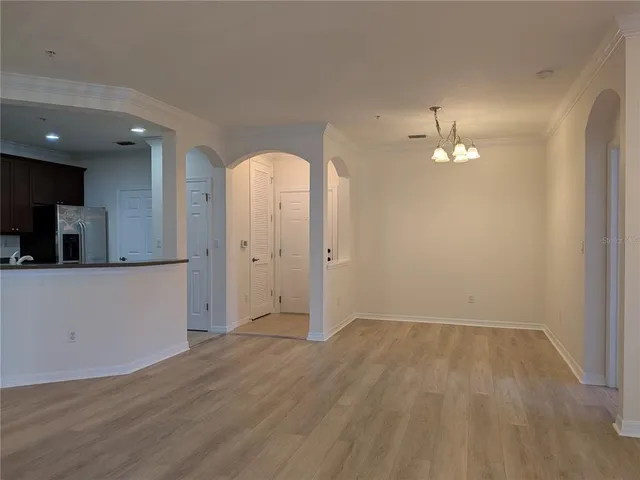 a view of kitchen with stainless steel appliances granite countertop a refrigerator and a stove top oven