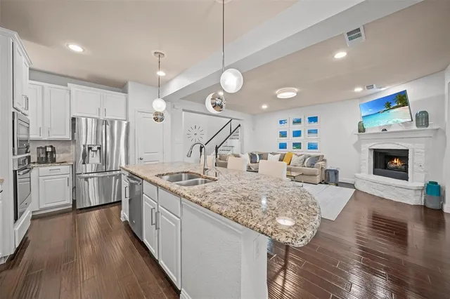 a kitchen with stainless steel appliances granite countertop a stove oven and a refrigerator