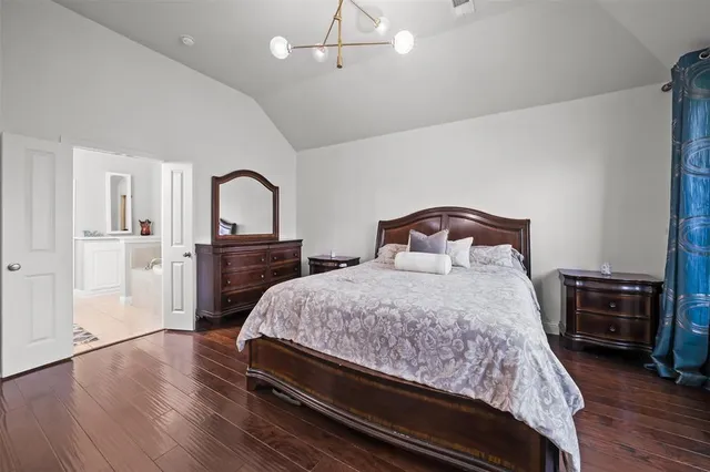 a bedroom with a bed and a television