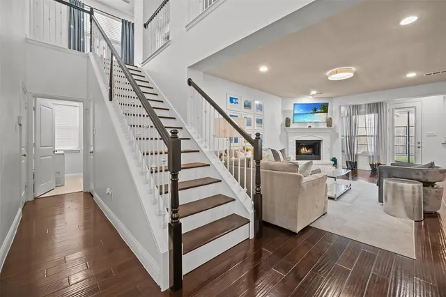a view of entryway and hall with wooden floor