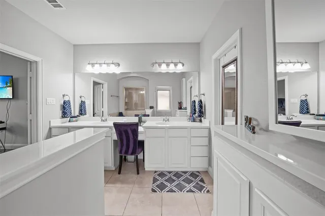 a large white kitchen with a white countertops and fireplace
