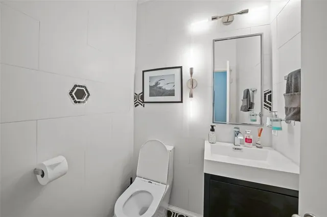 a bathroom with a sink toilet and a mirror