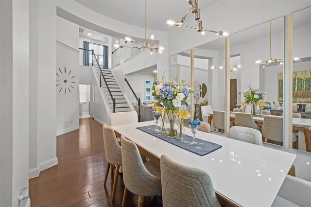 a dining room with furniture and wooden floor