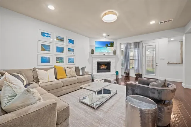 a living room with furniture fireplace and a flat screen tv