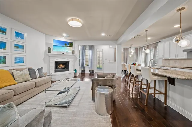 a living room with furniture fireplace and a table