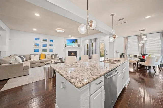 a large kitchen with lots of counter space and view of living room