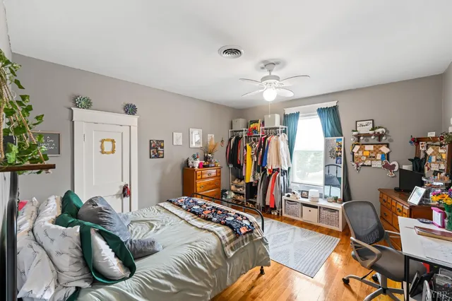 a bedroom with a bed and a desk