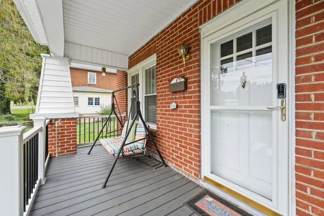 a view of a balcony with wooden floor and fence