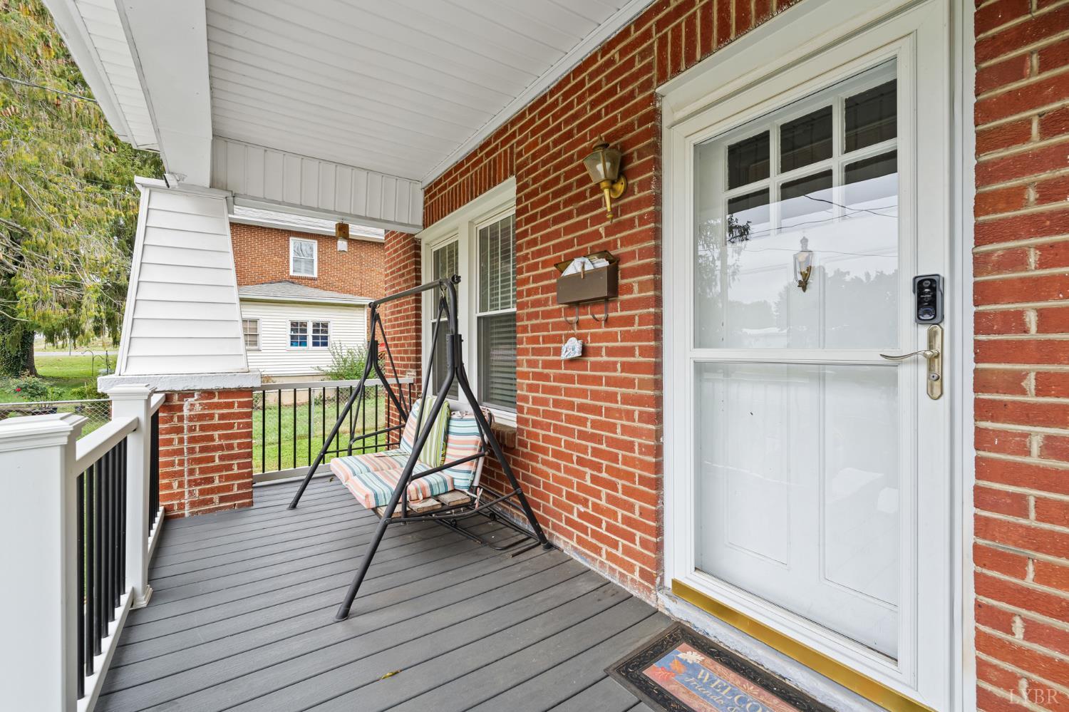 809 Broad Street Altavista, VA 24517 - Photo 7 of 50 a view of a balcony with wooden floor and fence