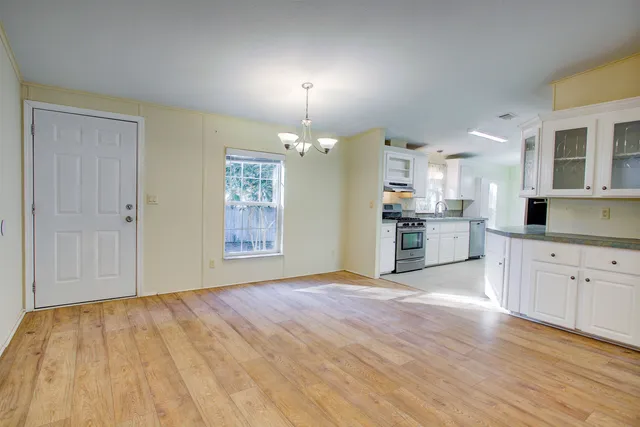 a kitchen with a sink stove and cabinets