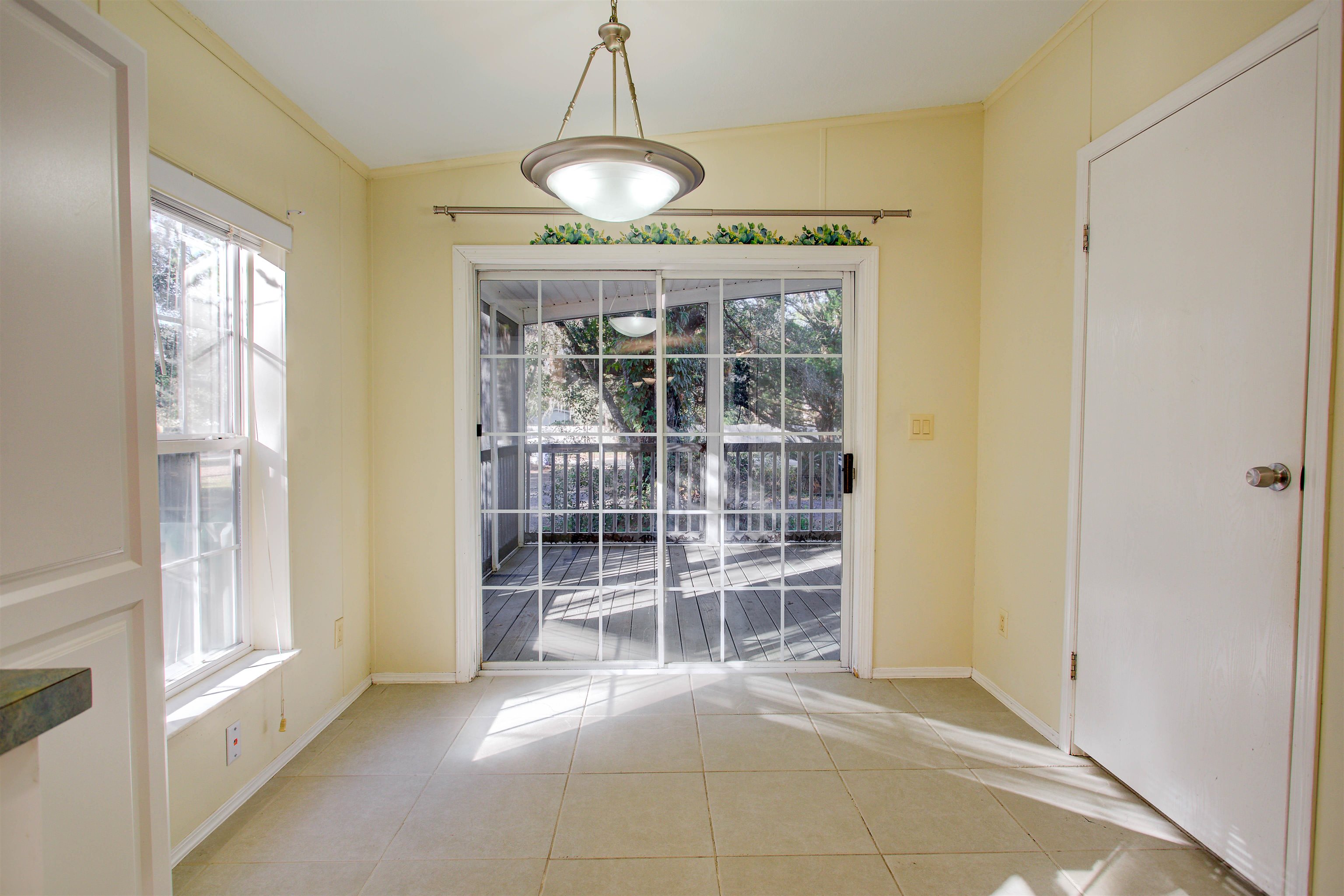 501 Hayley Road St. Augustine, FL 32086 - Photo 19 of 49 Unfurnished dining area with light tile patterned floors and crown molding