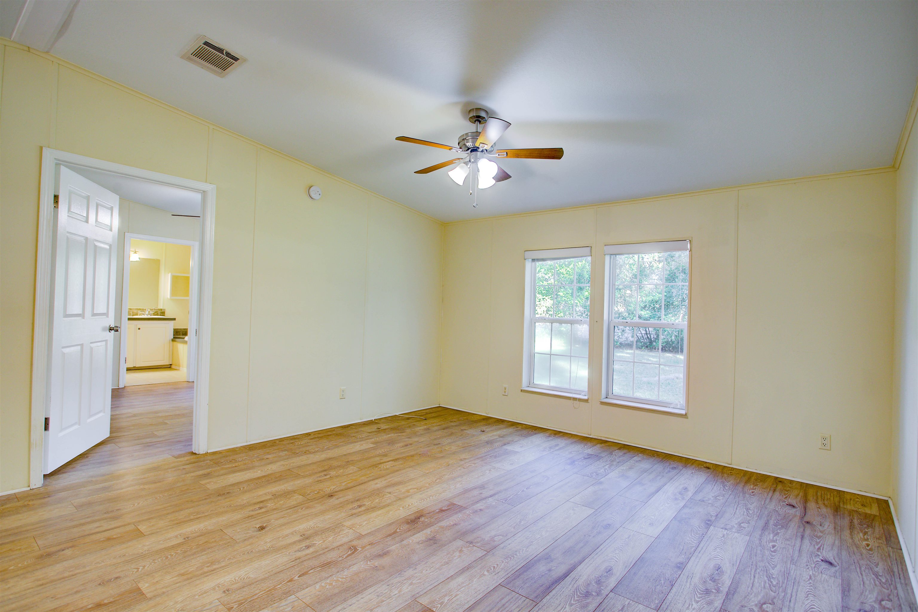 501 Hayley Road St. Augustine, FL 32086 - Photo 7 of 49 Unfurnished room with light wood-style floors, crown molding, and a ceiling fan