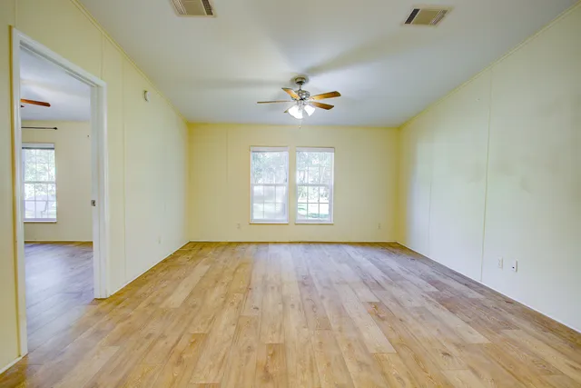 a view of a kitchen with cabinets and wooden floor