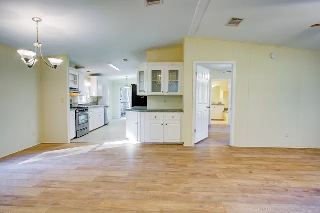 a view of a kitchen with wooden floor