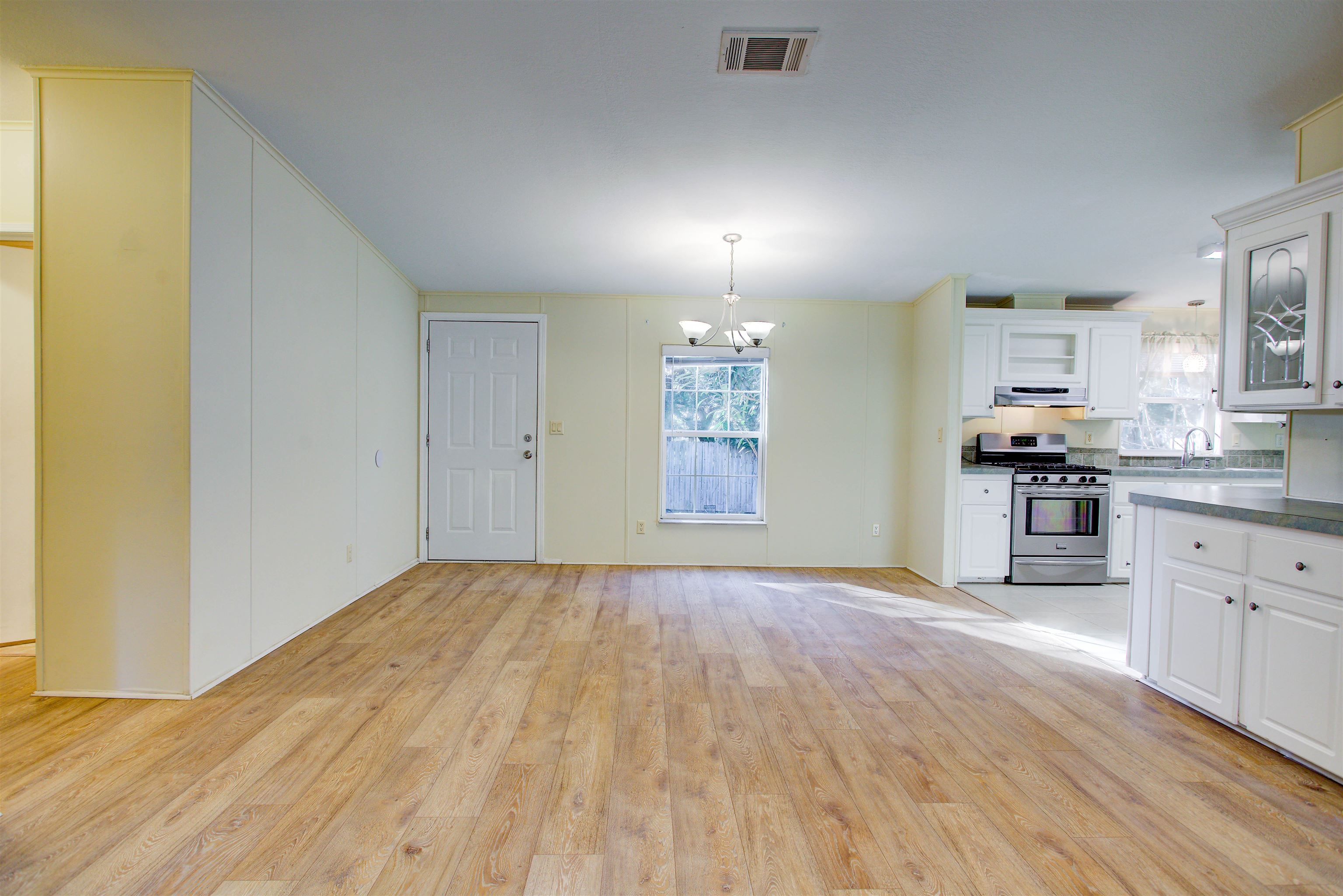 501 Hayley Road St. Augustine, FL 32086 - Photo 10 of 49 Kitchen featuring pendant lighting, a chandelier, white cabinets, and stainless steel gas stove