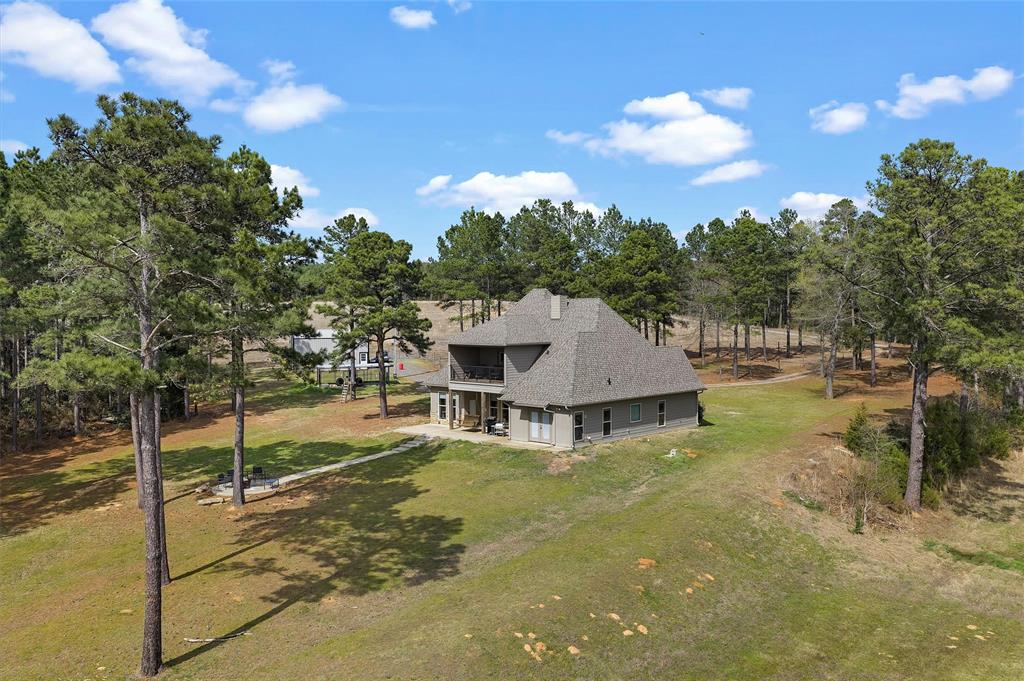 279 Lake Road Plain Dealing, LA 71064 - Photo 11 of 38 a view of a house with pool and a yard