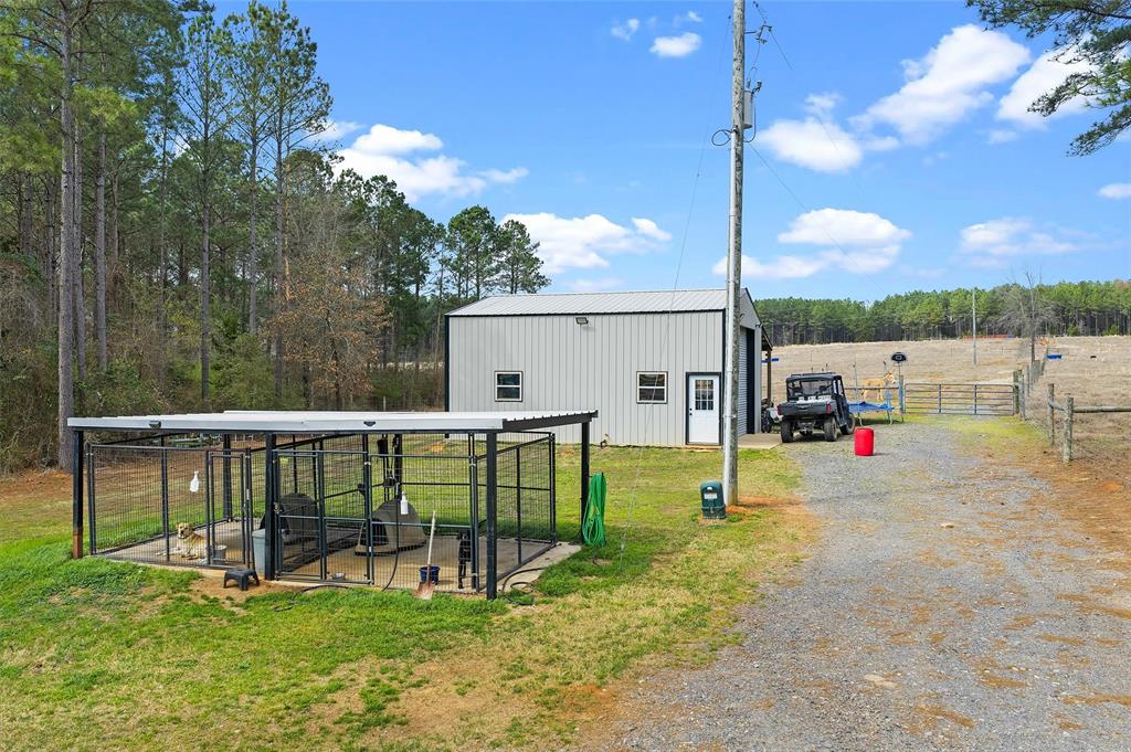 279 Lake Road Plain Dealing, LA 71064 - Photo 14 of 38 a view of playground with a slide and swing