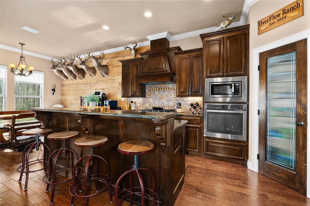 279 Lake Road Plain Dealing, LA 71064 - Photo 20 of 38 a kitchen with stainless steel appliances granite countertop a sink and a refrigerator