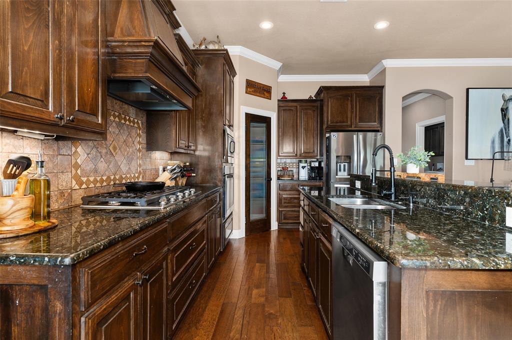279 Lake Road Plain Dealing, LA 71064 - Photo 21 of 38 a kitchen with stainless steel appliances granite countertop a stove a sink and a microwave