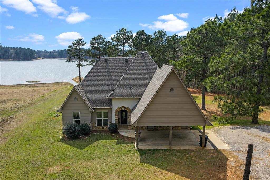 279 Lake Road Plain Dealing, LA 71064 - Photo 4 of 38 a aerial view of a house with swimming pool and a yard
