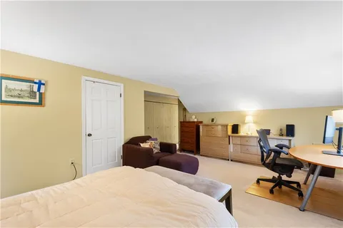 a bathroom with a sink a mirror a toilet and shower