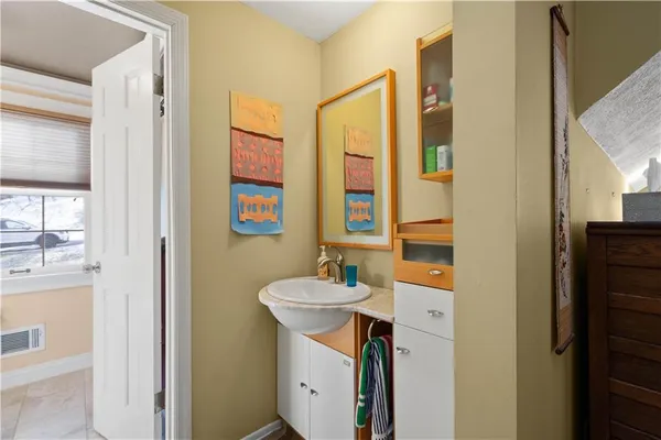 a bathroom with a toilet a sink and a large mirror