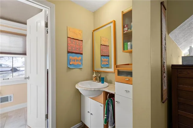 a bathroom with a toilet a sink and a large mirror