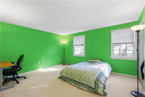 a bedroom with a bed and a chair