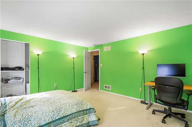 a view of a workspace with furniture and a flat screen tv