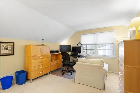 a livingroom with workspace and a window
