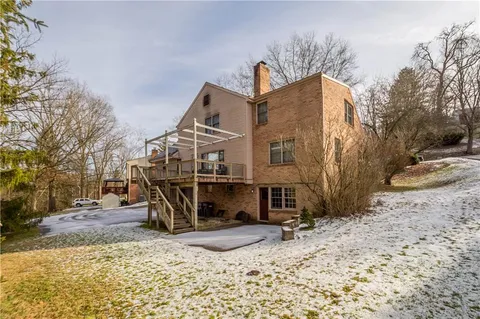 a view of a house with a yard and sitting area