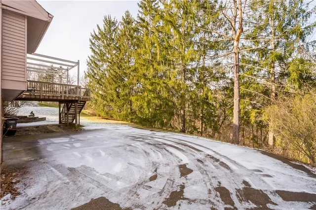 an aerial view of residential building with outdoor space and trees