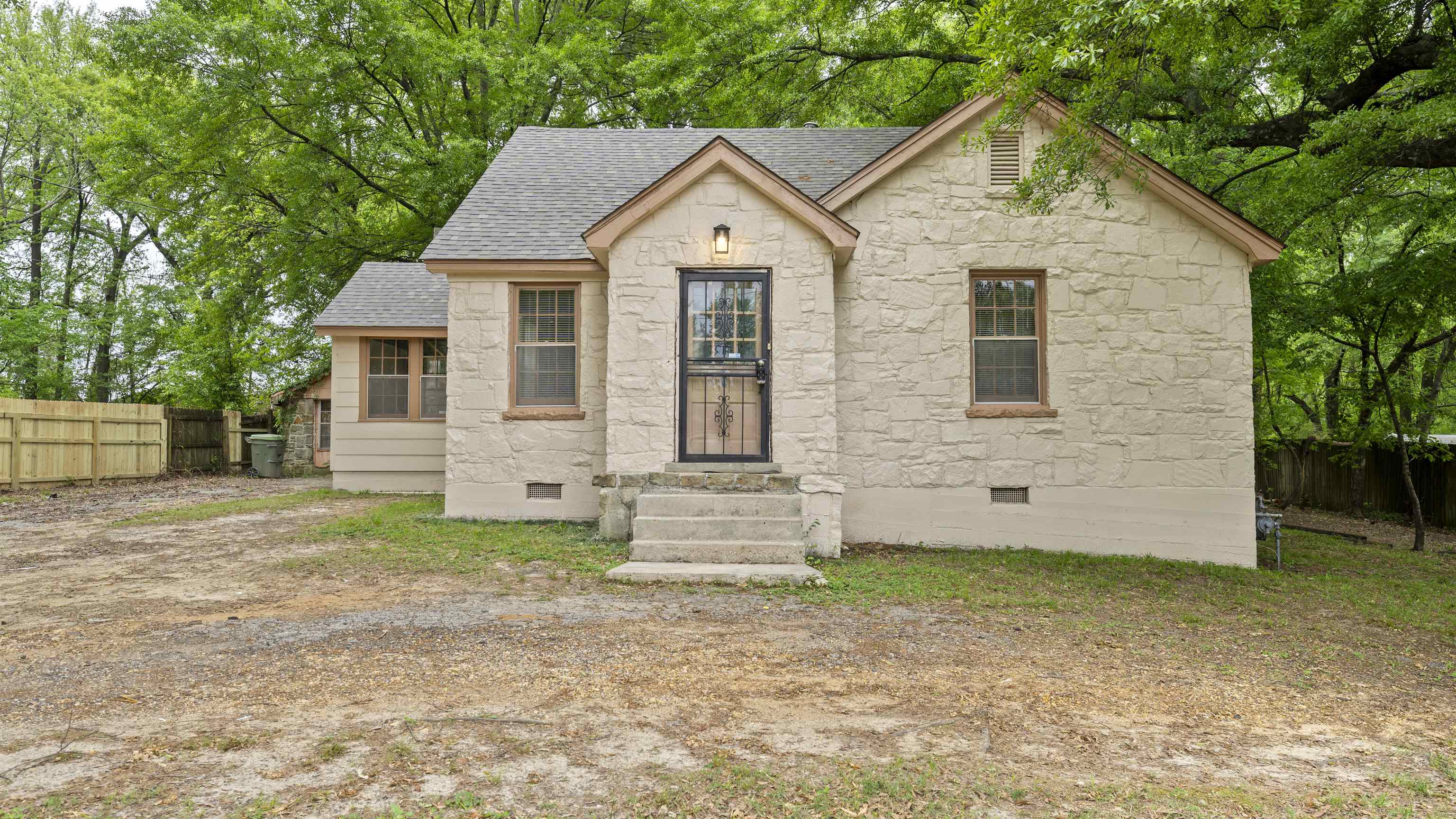 93 Eastman Road Memphis, TN 38109 - Photo 1 of 18 a front view of a house with a garden