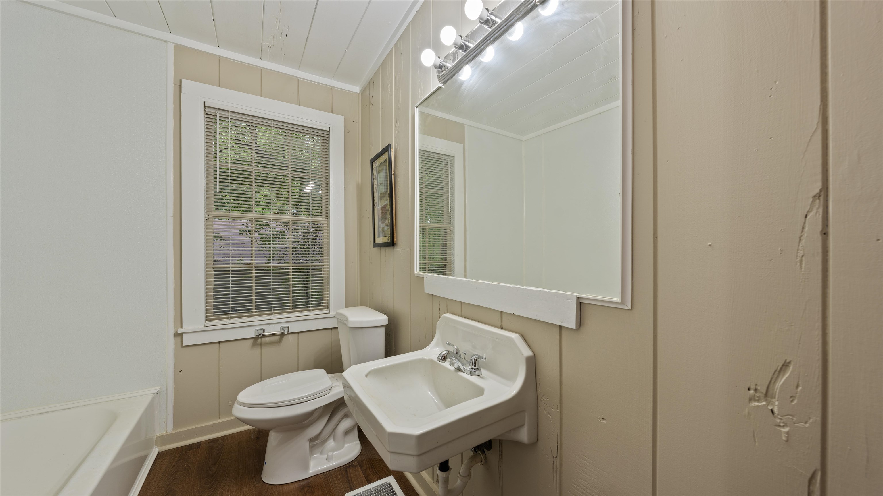 93 Eastman Road Memphis, TN 38109 - Photo 17 of 18 a bathroom with a toilet sink and mirror