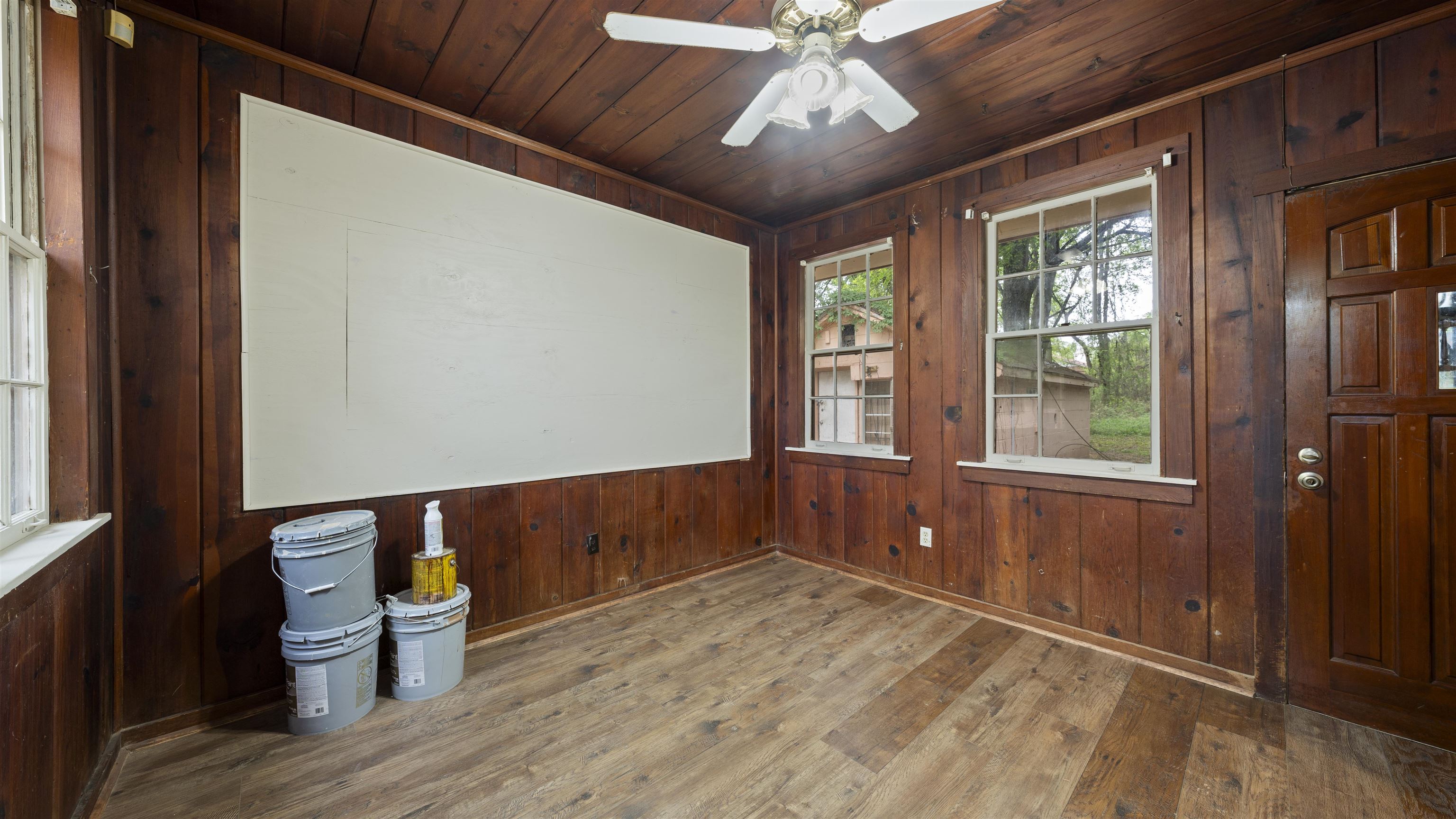93 Eastman Road Memphis, TN 38109 - Photo 8 of 18 a view of an empty room with a window and wooden floor