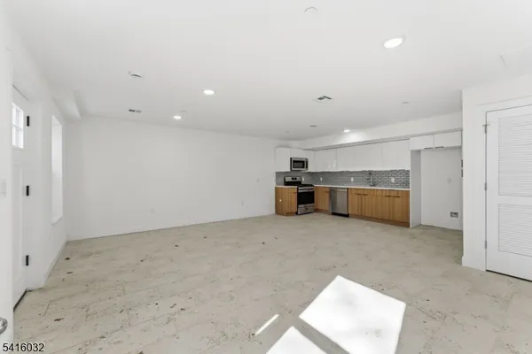 a kitchen with a refrigerator sink and oven