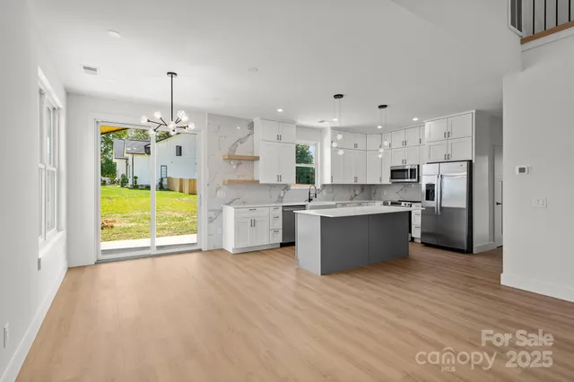 a view of a kitchen with a sink and a stove top oven