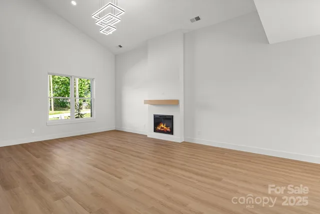 a kitchen with a refrigerator a sink and white cabinets