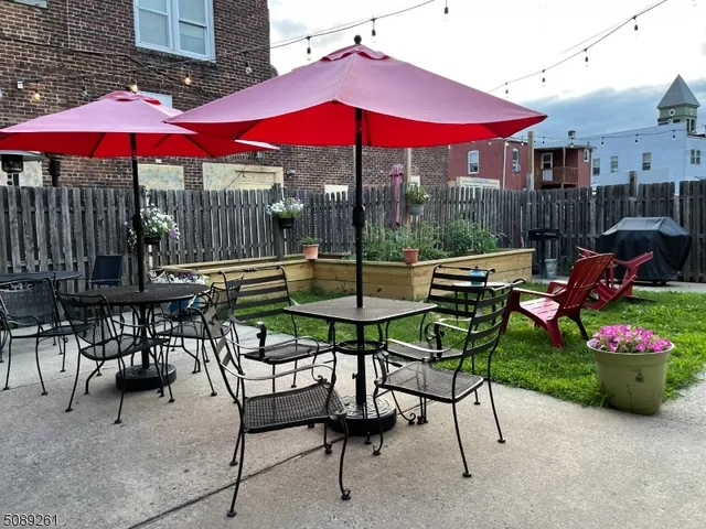 a view of a patio with a table and chairs under an umbrella