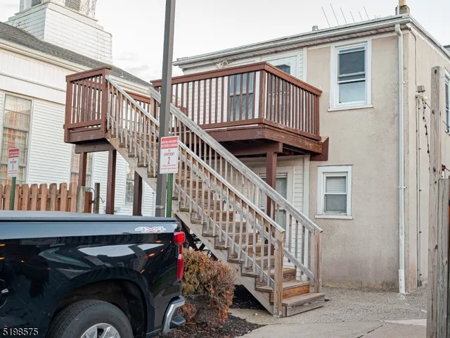 a view of a house with wooden deck