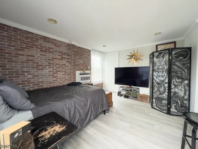 a bedroom with a bed and flat screen tv